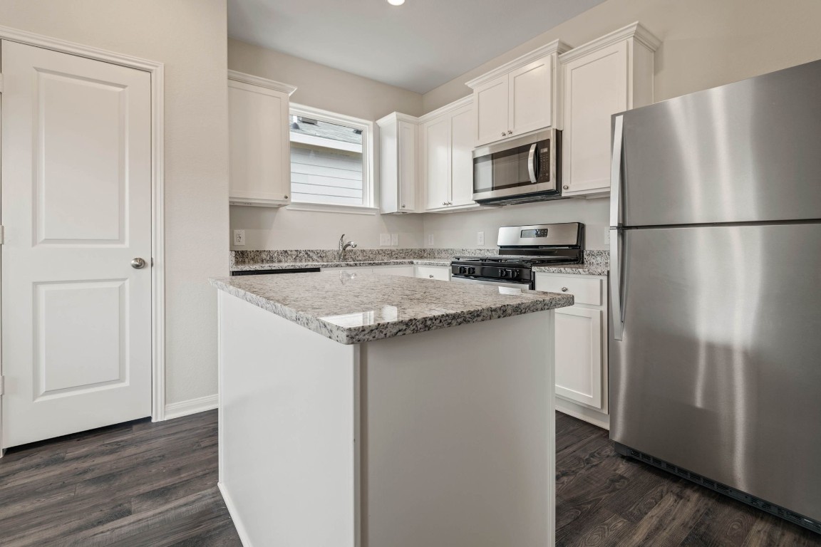 345 Fastboy Lane Waller, TX 77484 - Photo 6 of 12 a kitchen with a refrigerator stove and microwave