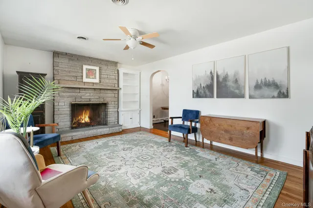 a living room with furniture and a fireplace