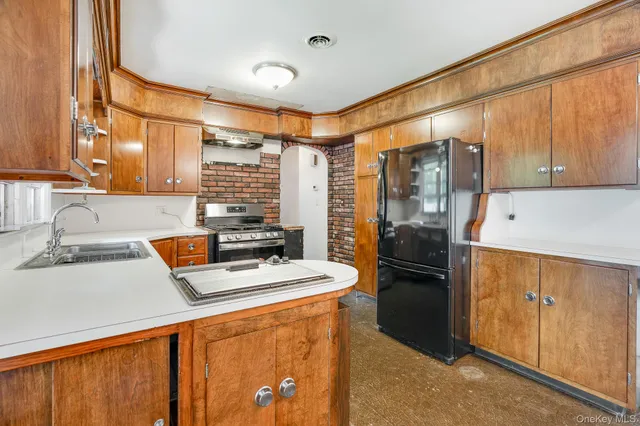 a kitchen with stainless steel appliances granite countertop a refrigerator and a sink