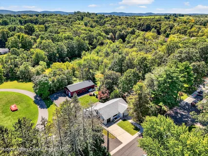 an aerial view of a house with a yard