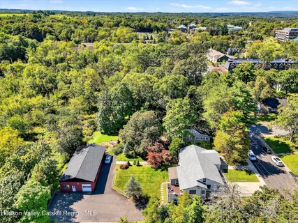 an aerial view of a house with yard swimming pool and outdoor seating