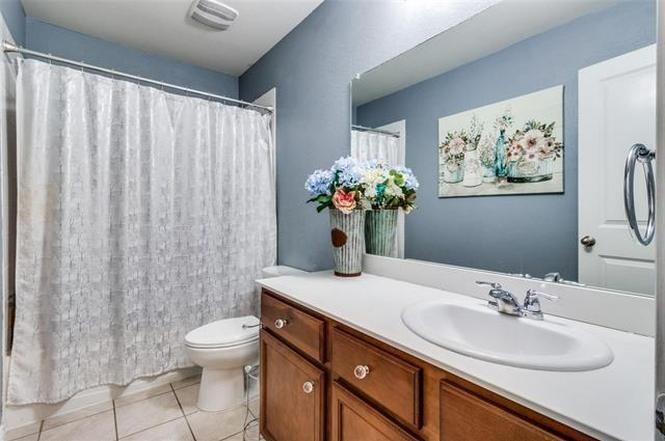 3330 Emerson Road Forney, TX 75126 - Photo 1 of 10 a bathroom with a granite countertop sink a toilet and a mirror