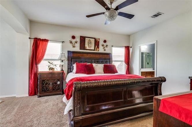 3330 Emerson Road Forney, TX 75126 - Photo 6 of 10 a bedroom with a bed and a chandelier