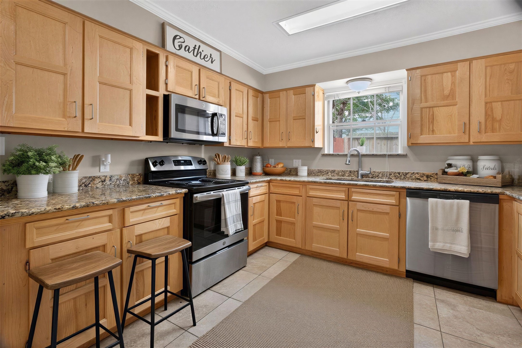 27210 Jimmy Lane Conroe, TX 77385 - Photo 12 of 43 a kitchen with stainless steel appliances granite countertop a stove a sink dishwasher and a microwave oven with cabinets