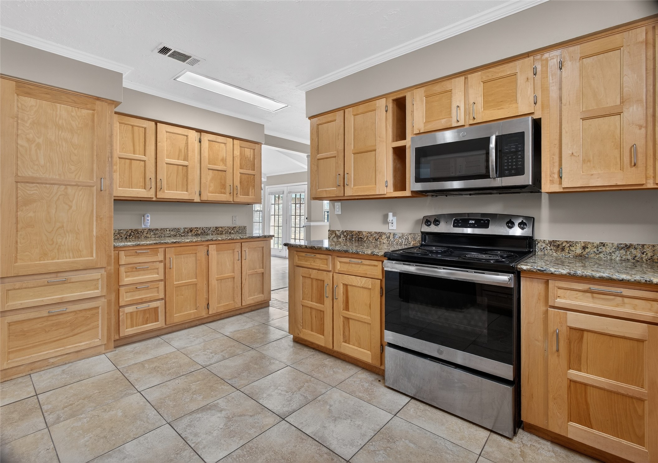 27210 Jimmy Lane Conroe, TX 77385 - Photo 13 of 43 a kitchen with stainless steel appliances granite countertop a stove top oven a sink dishwasher and white cabinets with wooden floor