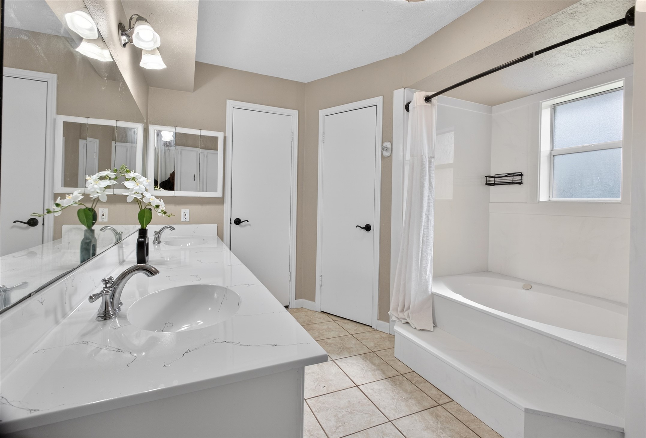27210 Jimmy Lane Conroe, TX 77385 - Photo 21 of 43 a bathroom with a bathtub a sink and a mirror