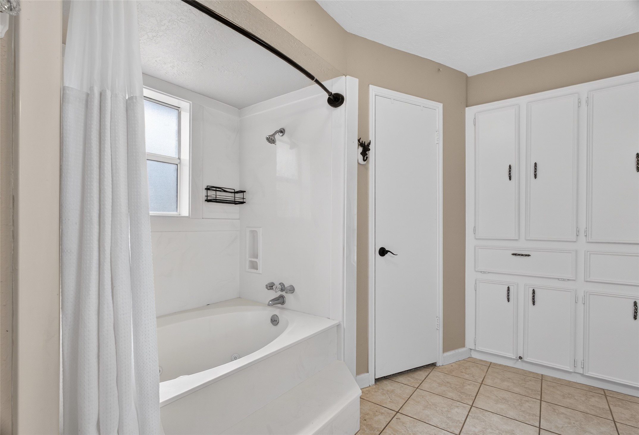 27210 Jimmy Lane Conroe, TX 77385 - Photo 23 of 43 a bathroom with a bathtub and a shower