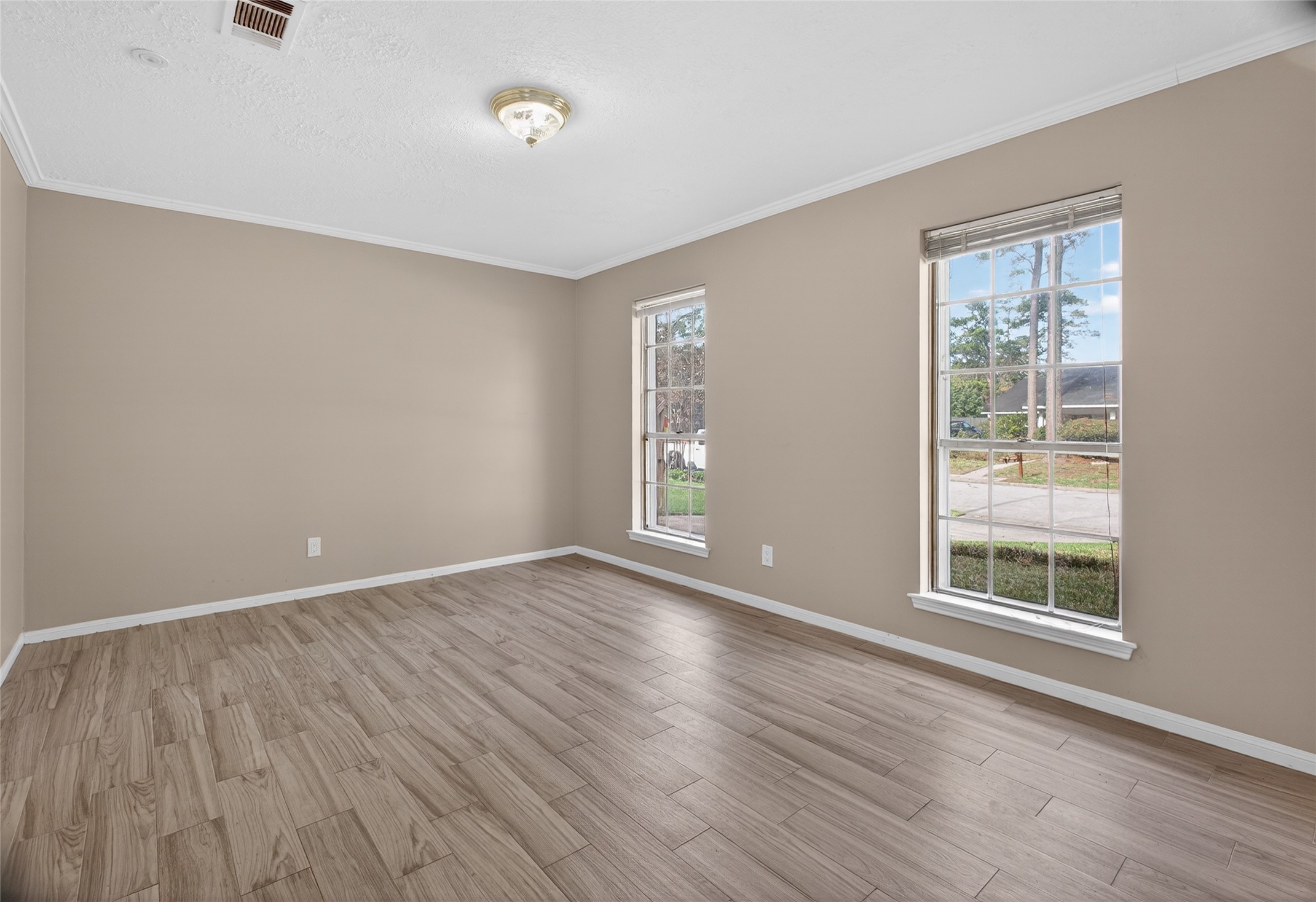 27210 Jimmy Lane Conroe, TX 77385 - Photo 4 of 43 a view of an empty room with wooden floor and a window