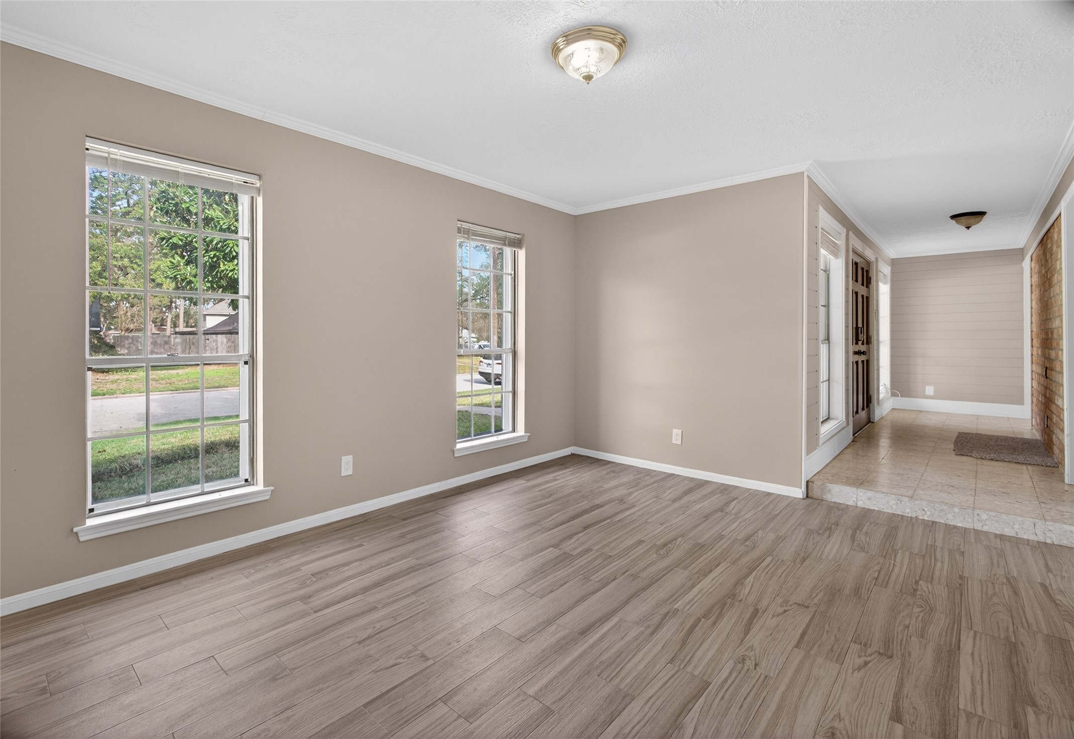 27210 Jimmy Lane Conroe, TX 77385 - Photo 6 of 43 an empty room with wooden floor and windows