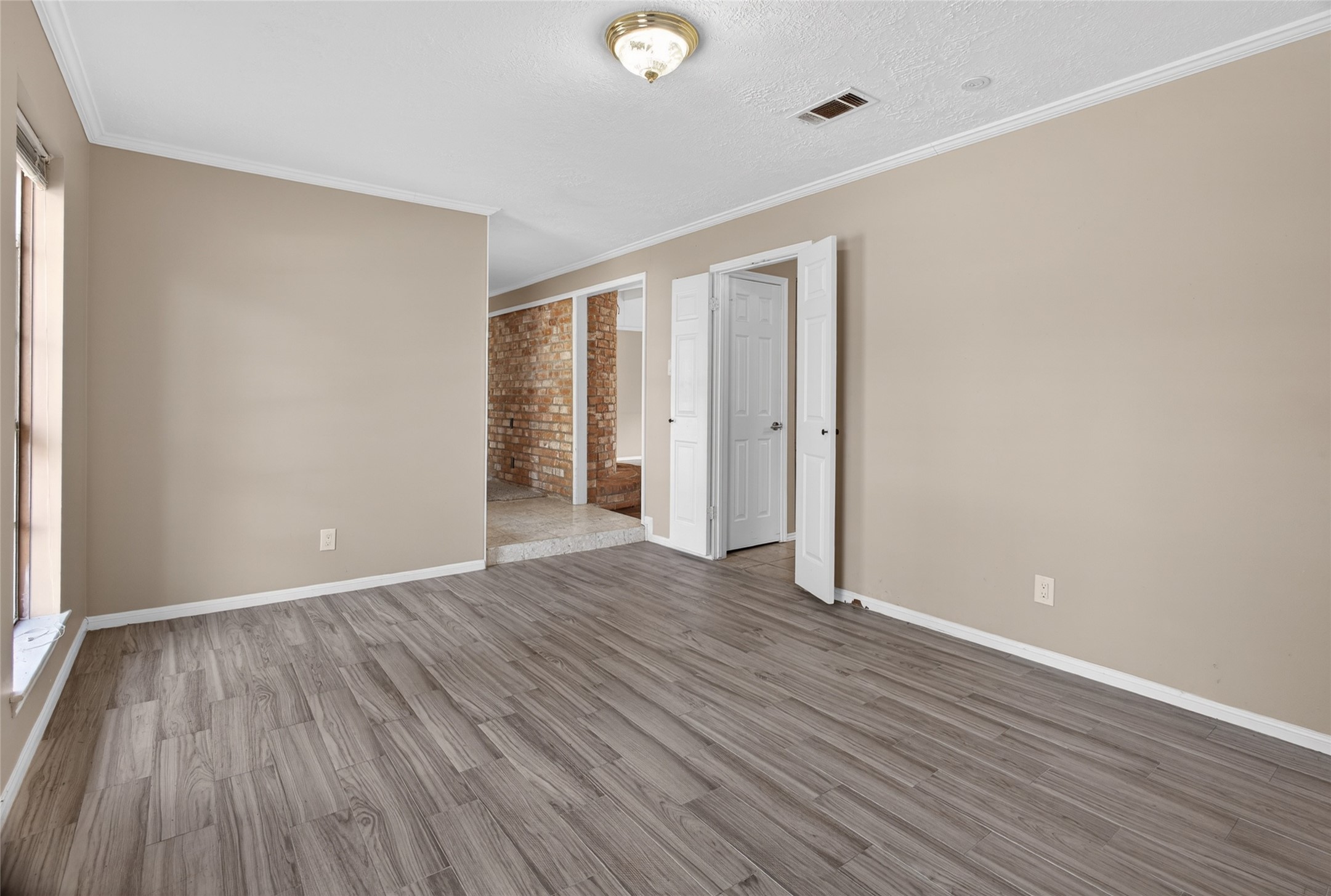 27210 Jimmy Lane Conroe, TX 77385 - Photo 7 of 43 a view of an empty room with wooden floor and a window