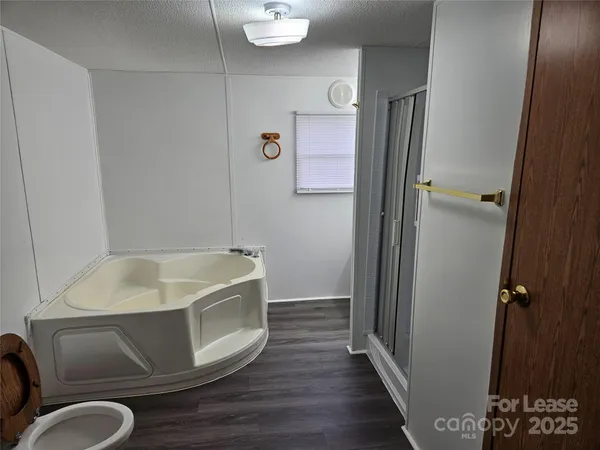 a bathroom with a tub and toilet