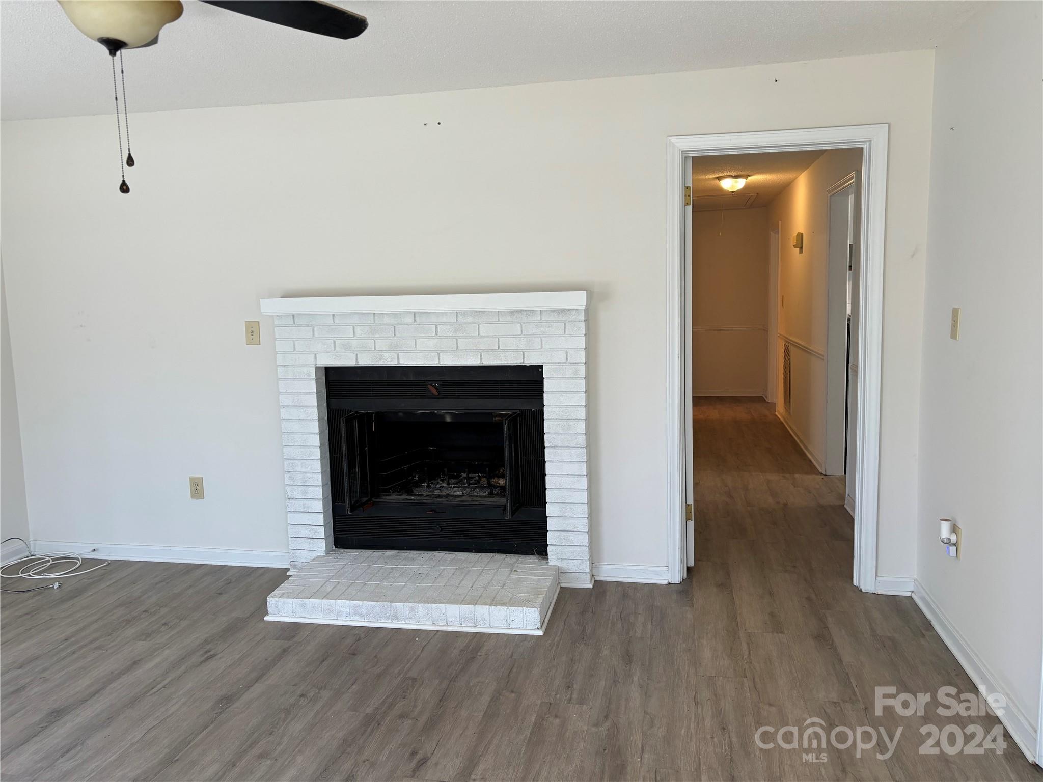 2145 East Holly Grove Road Lexington, NC 27292 - Photo 4 of 19 a view of a livingroom with a fireplace and wooden floor