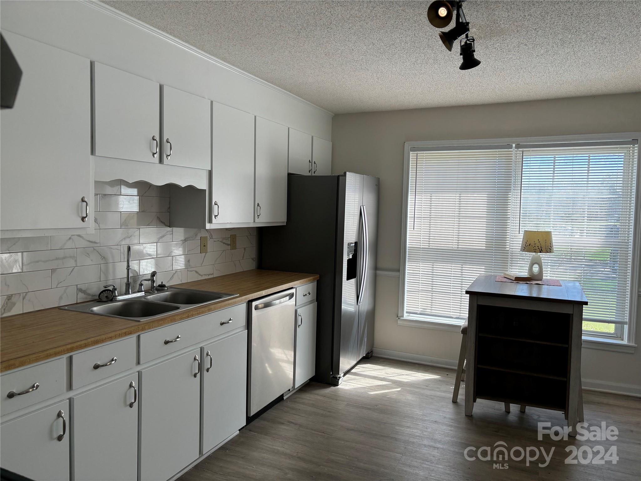 2145 East Holly Grove Road Lexington, NC 27292 - Photo 7 of 19 a kitchen with stainless steel appliances granite countertop a refrigerator sink and white cabinets