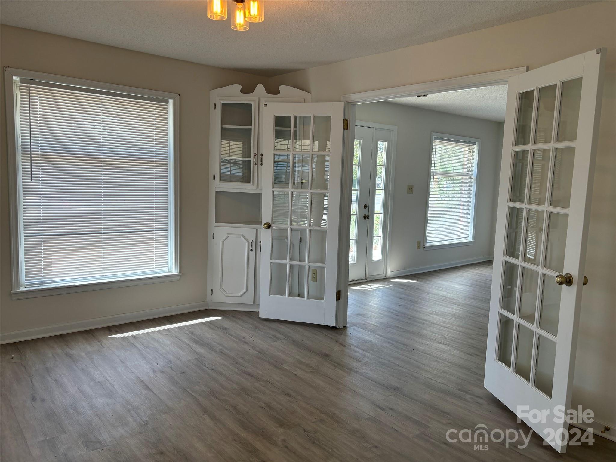 2145 East Holly Grove Road Lexington, NC 27292 - Photo 10 of 19 an empty room with wooden floor and windows