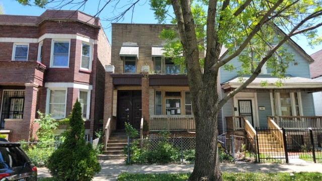 front view of house with a tree in front
