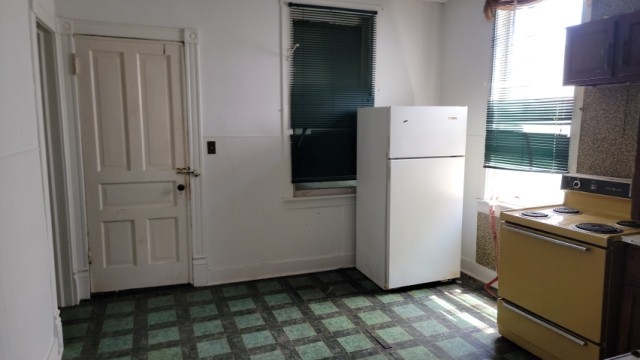 5751 South Carpenter Street Chicago, IL 60621 - Photo 7 of 10 a view of a kitchen with a refrigerator