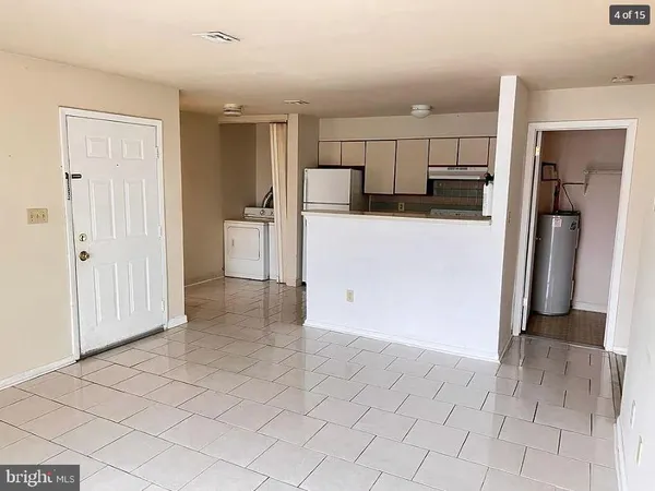 a view of a refrigerator in kitchen and entryway