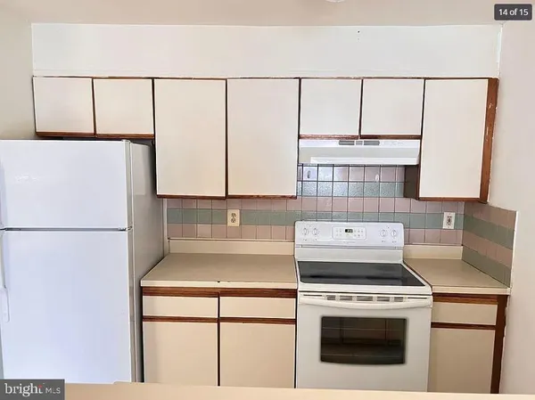 a stove top oven sitting inside of a kitchen
