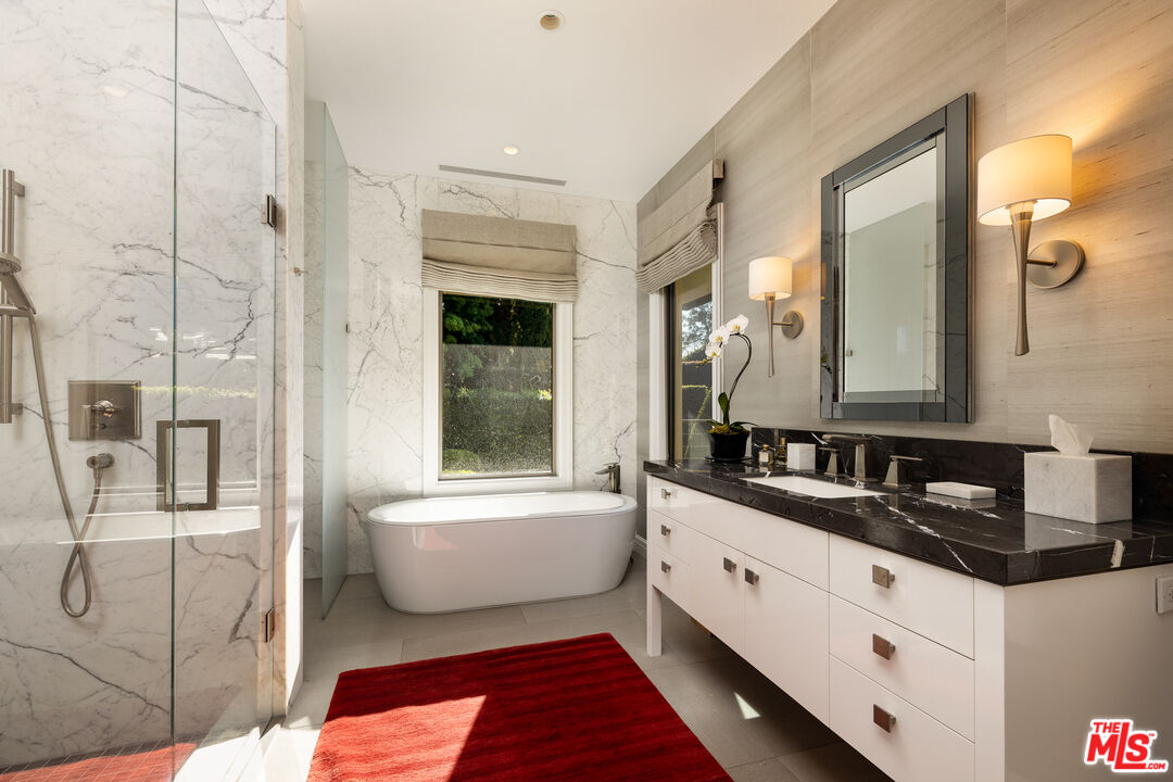 2076 China Flat Road Santa Barbara, CA 93108 - Photo 16 of 27 a bathroom with a double vanity sink a mirror and a bathtub