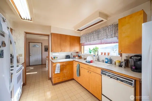 a kitchen with stainless steel appliances granite countertop a sink and cabinets