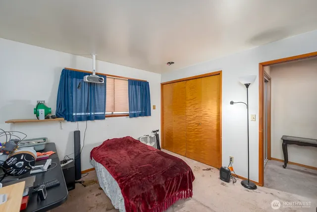 a bedroom with a bed and a dresser in it