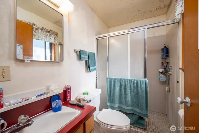 a bathroom with a sink mirror vanity and toilet
