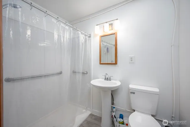a bathroom with a sink toilet and shower