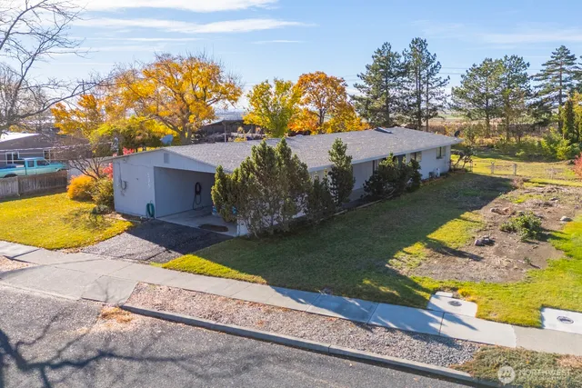 a view of a house with a yard and a pool