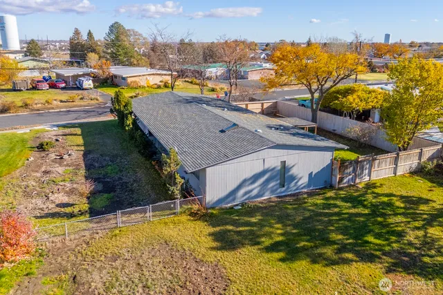 a swimming pool with outdoor seating and yard