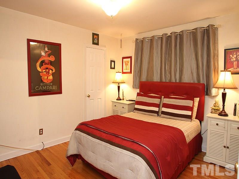 3101 Brentwood Road Raleigh, NC 27604 - Photo 8 of 17 a bedroom with a bed and a painting on the wall
