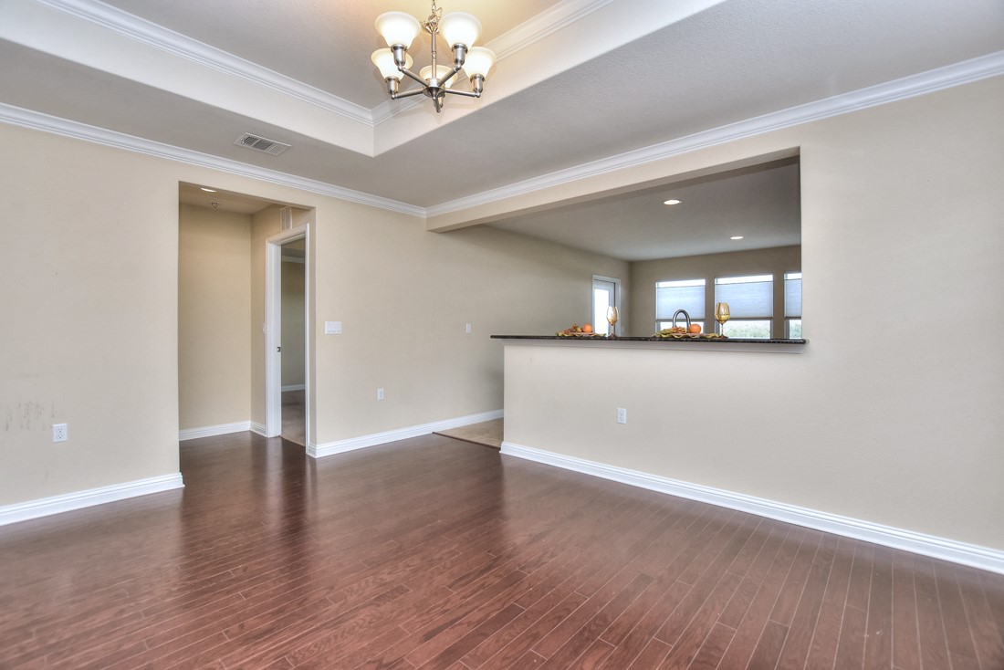 106 Kickapoo Creek Lane Georgetown, TX 78633 - Photo 12 of 33 a view of a hallway with wooden floor and a chandelier