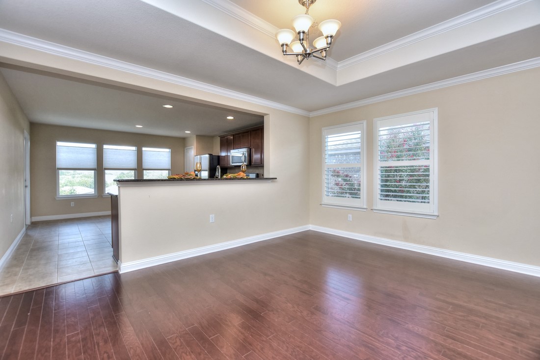 106 Kickapoo Creek Lane Georgetown, TX 78633 - Photo 13 of 33 a view of an empty room with a window and wooden floor