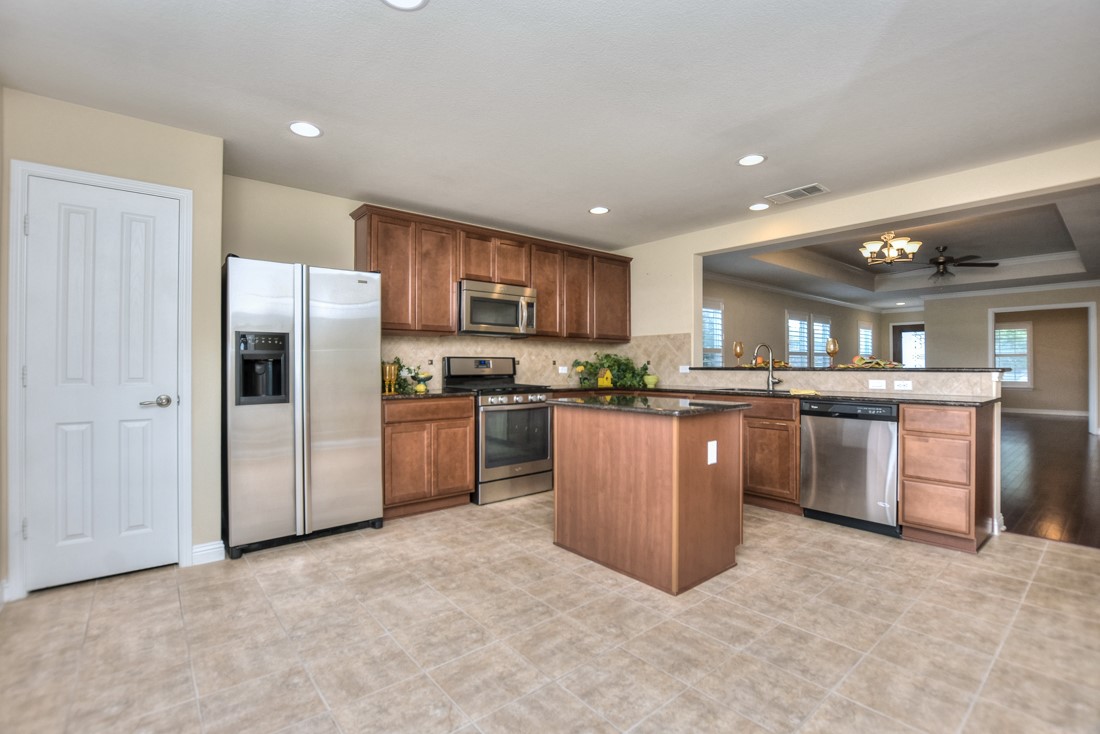 106 Kickapoo Creek Lane Georgetown, TX 78633 - Photo 16 of 33 a kitchen with stainless steel appliances granite countertop a refrigerator a sink and a stove