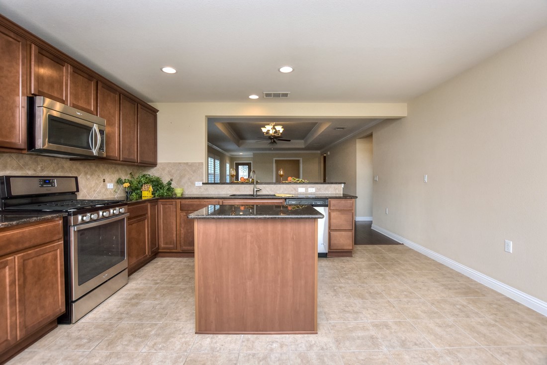 106 Kickapoo Creek Lane Georgetown, TX 78633 - Photo 17 of 33 a kitchen with stainless steel appliances granite countertop a stove a sink dishwasher and a refrigerator