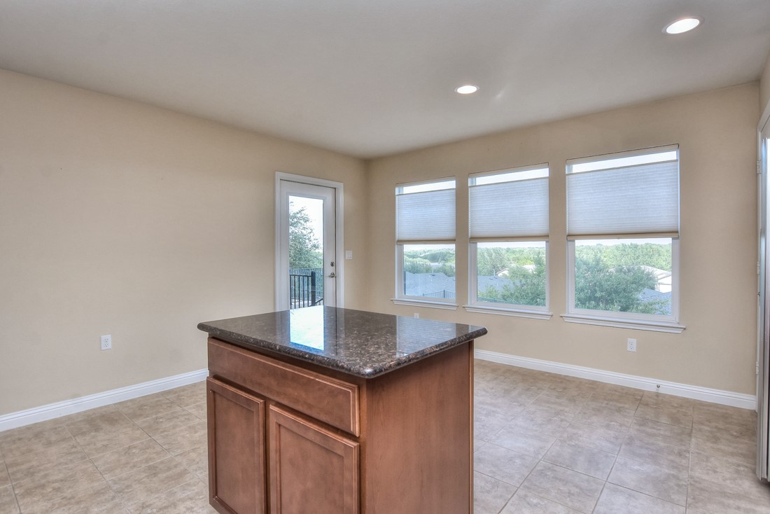106 Kickapoo Creek Lane Georgetown, TX 78633 - Photo 18 of 33 a kitchen with granite countertop a sink and a window