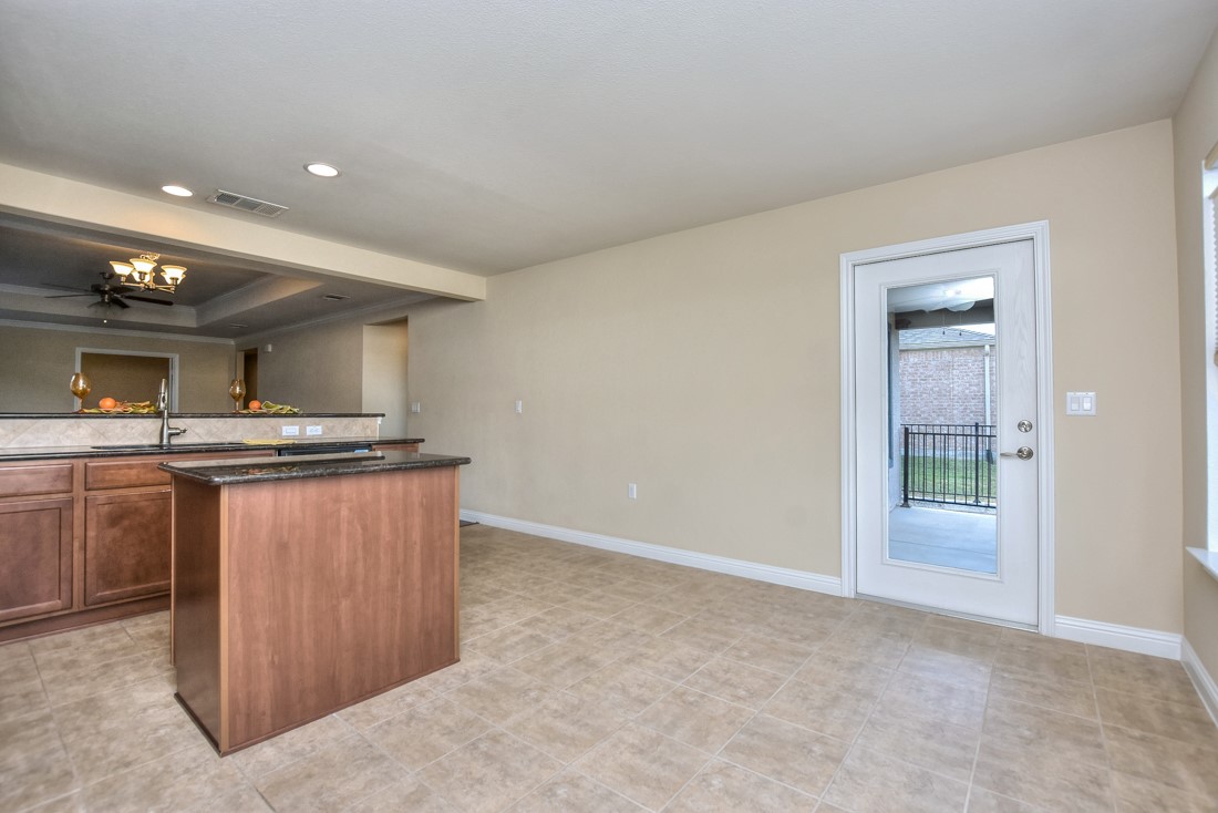 106 Kickapoo Creek Lane Georgetown, TX 78633 - Photo 19 of 33 a view of kitchen with kitchen island a sink a stove and a refrigerator