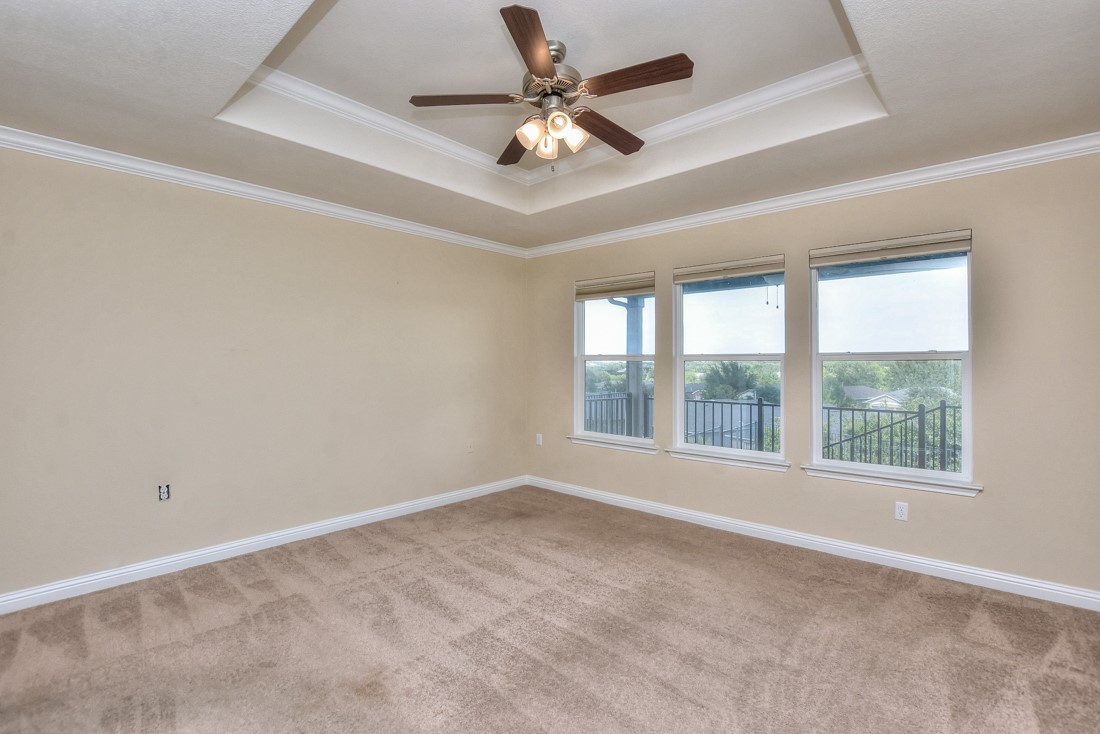106 Kickapoo Creek Lane Georgetown, TX 78633 - Photo 20 of 33 an empty room with chandelier fan and windows