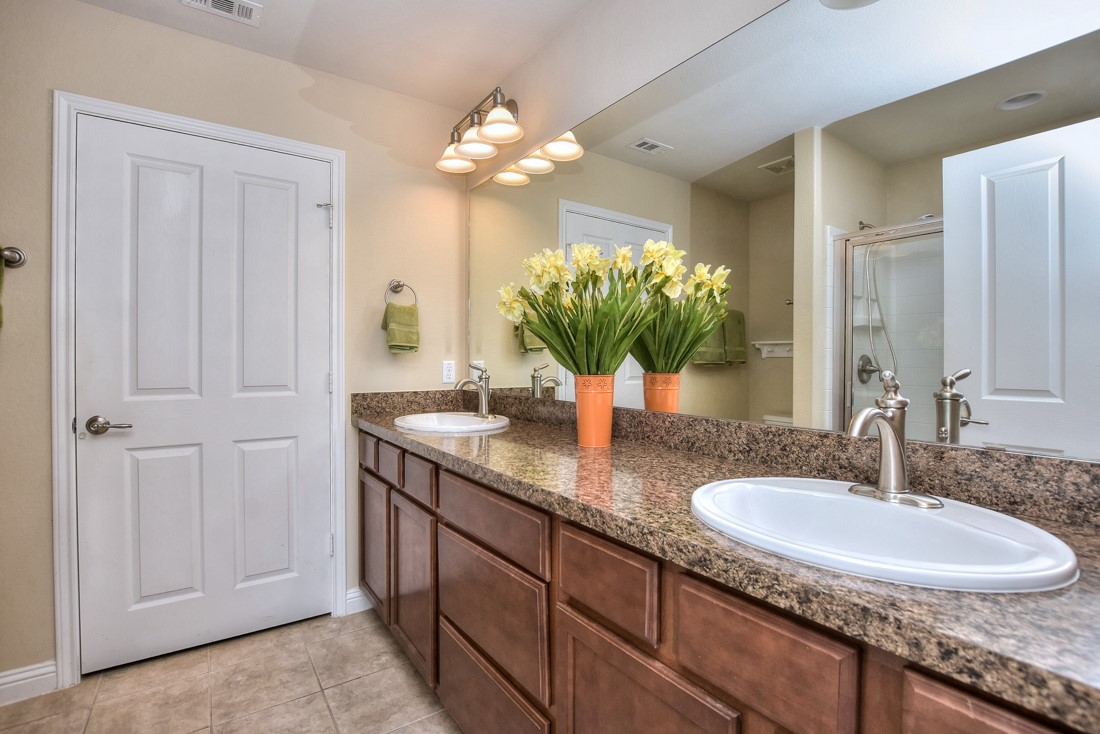 106 Kickapoo Creek Lane Georgetown, TX 78633 - Photo 22 of 33 a bathroom with a granite countertop double vanity and a mirror