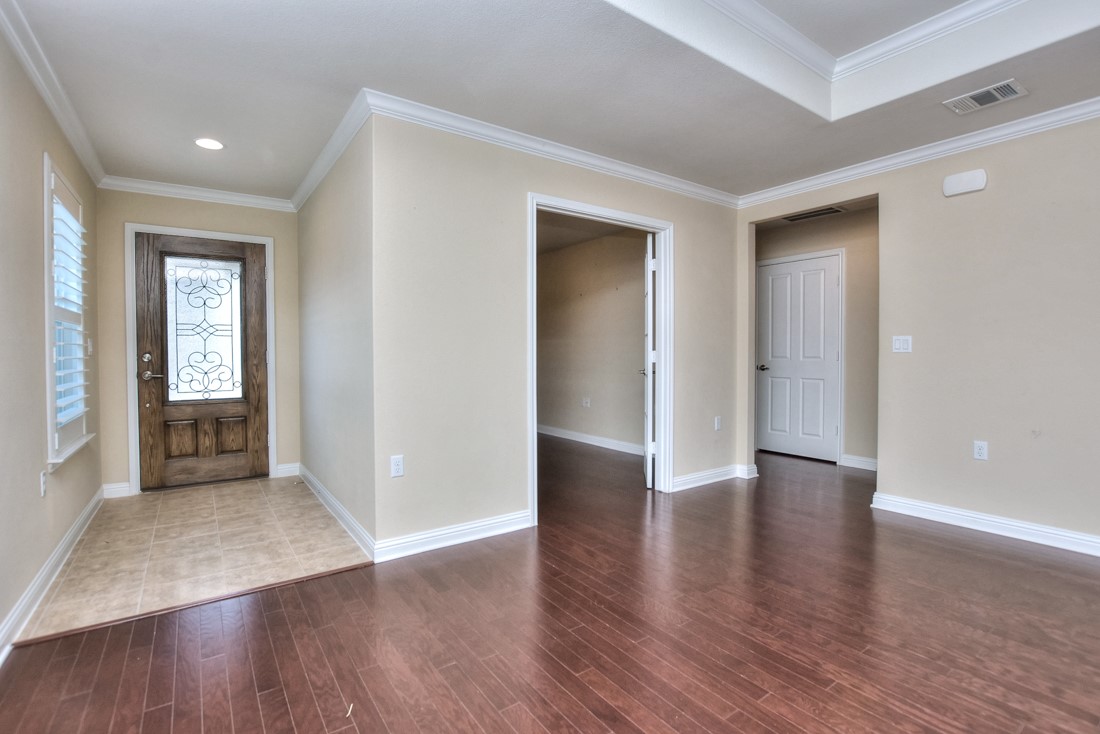 106 Kickapoo Creek Lane Georgetown, TX 78633 - Photo 5 of 33 an empty room with wooden floor and windows