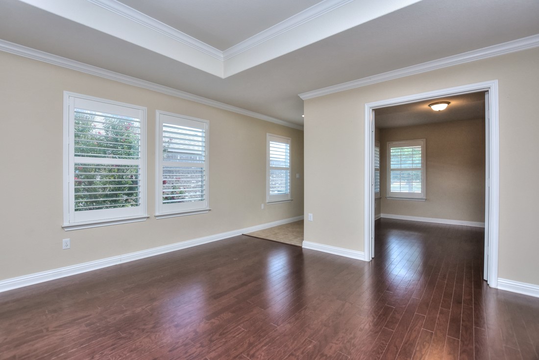 106 Kickapoo Creek Lane Georgetown, TX 78633 - Photo 6 of 33 an empty room with wooden floor and windows