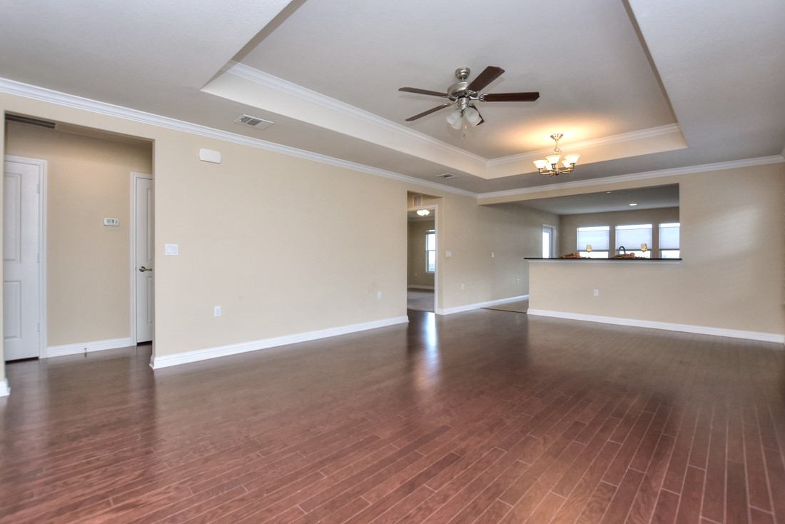 106 Kickapoo Creek Lane Georgetown, TX 78633 - Photo 9 of 33 a view of a livingroom with wooden floor and a ceiling fan