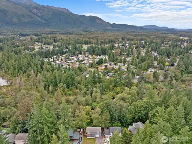 an aerial view of a house with a yard