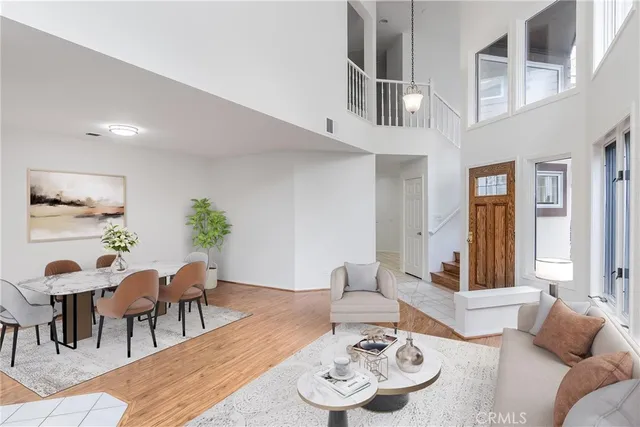 a living room with furniture and dining table