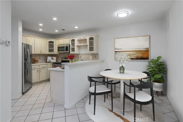 a kitchen with stainless steel appliances kitchen island granite countertop a sink and cabinets