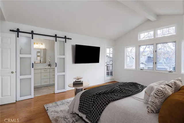 a bedroom with a bed and a flat screen tv