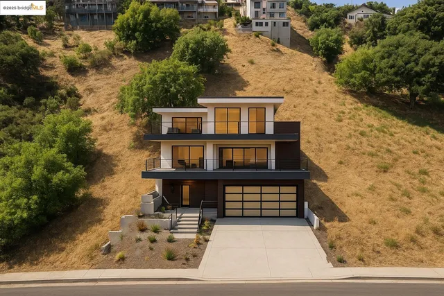 a view of a brick house with a small yard