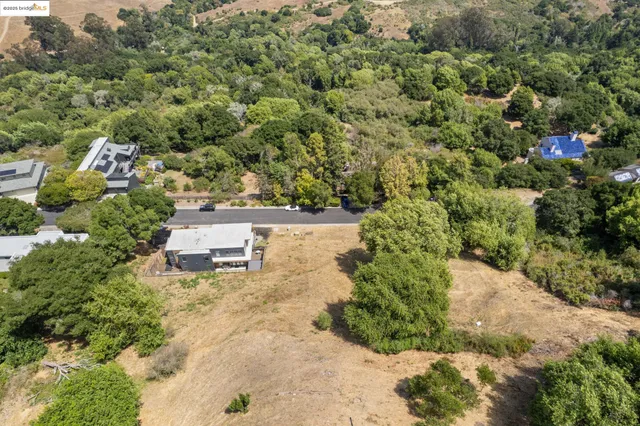 a backyard of a house with a yard and outdoor seating