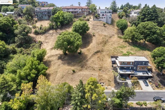 an aerial view of a house with a yard and lake view