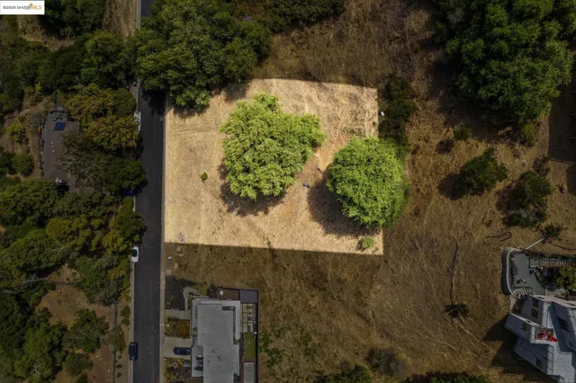 an aerial view of a residential houses with yard