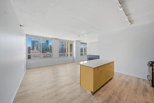 a kitchen with granite countertop a stove and a sink